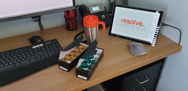 Branded flask at a computer