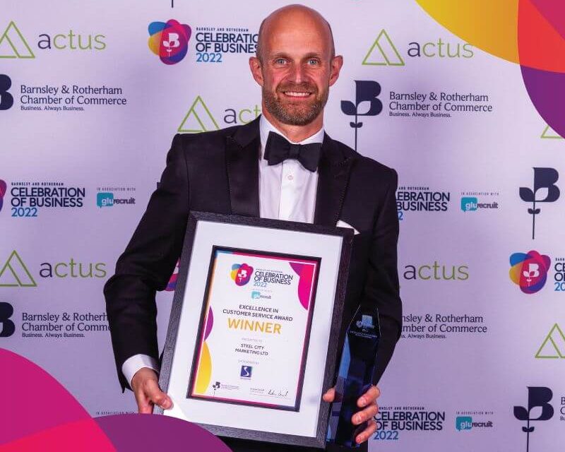 James Biggin holding the Barnsley And Rotherham Customer Service Award