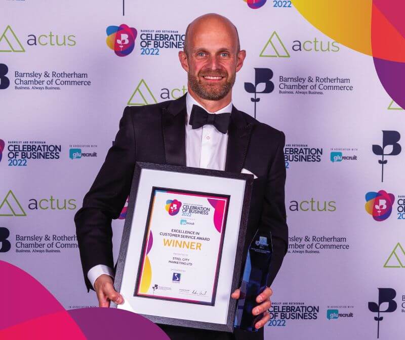 James Biggin holding the Barnsley And Rotherham Customer Service Award